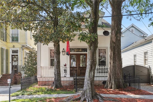 1212 Milan St, New Orleans, LA 70115 - view of front of house featuring a porch, a fenced front yard, and a gate