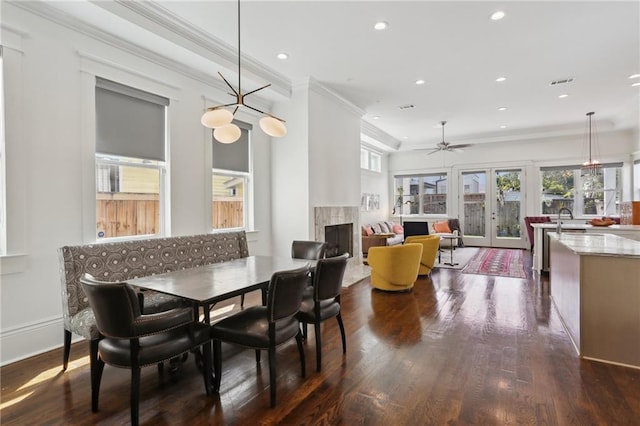 1212 Milan St, New Orleans, LA 70115 - dining space featuring a high end fireplace, dark wood-style floors, recessed lighting, a ceiling fan, and ornamental molding