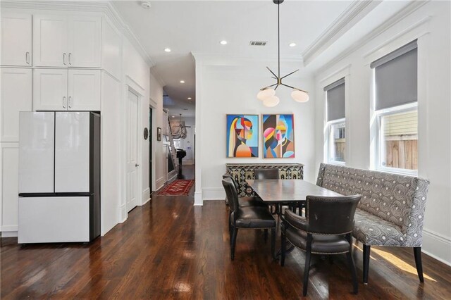 1212 Milan St, New Orleans, LA 70115 - dining space featuring dark wood-style flooring, crown molding, baseboards, and recessed lighting