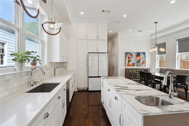 1212 Milan St, New Orleans, LA 70115 - kitchen featuring a sink, freestanding refrigerator, recessed lighting, pendant lighting, and tasteful backsplash