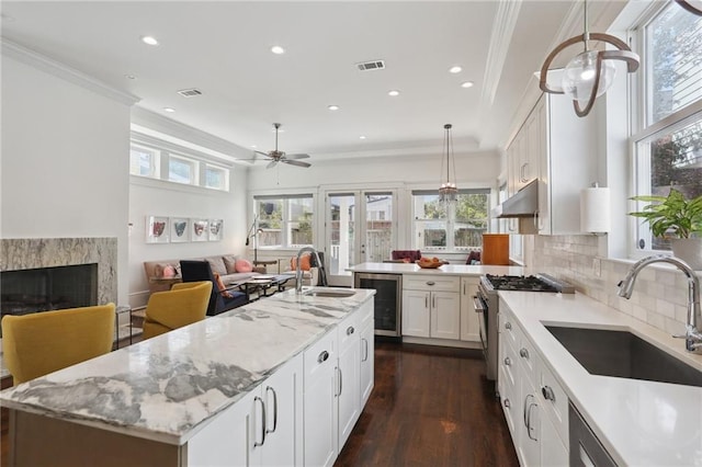 1212 Milan St, New Orleans, LA 70115 - kitchen with beverage cooler, a sink, open floor plan, crown molding, and recessed lighting
