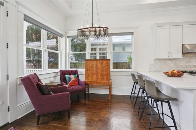1212 Milan St, New Orleans, LA 70115 - dining area with crown molding, dark wood-type flooring, a chandelier, and healthy amount of natural light