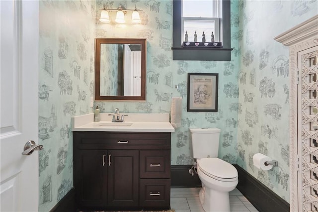 1212 Milan St, New Orleans, LA 70115 - bathroom featuring vanity, toilet, tile patterned floors, and wallpapered walls