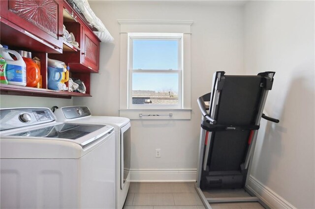 1212 Milan St, New Orleans, LA 70115 - laundry area with cabinet space, independent washer and dryer, baseboards, and light tile patterned floors