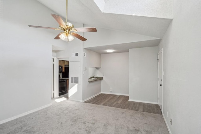 4218 Hessmer Ave Unit 309, Metairie, LA 70002 - unfurnished room featuring carpet, a ceiling fan, baseboards, high vaulted ceiling, and a skylight