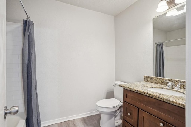 4218 Hessmer Ave Unit 309, Metairie, LA 70002 - bathroom with wood finished floors, vanity, toilet, and shower / bathtub combination with curtain