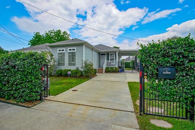 3927 Hamburg St, New Orleans, LA 70122 - view of front of home featuring driveway, a gate, an attached carport, and covered porch