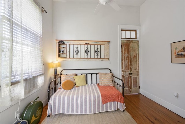 210911 Josephine St, New Orleans, LA 70113 - bedroom with wood finished floors, baseboards, and ceiling fan