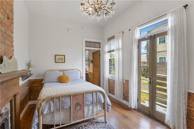 210911 Josephine St, New Orleans, LA 70113 - bedroom with hardwood / wood-style floors and a chandelier