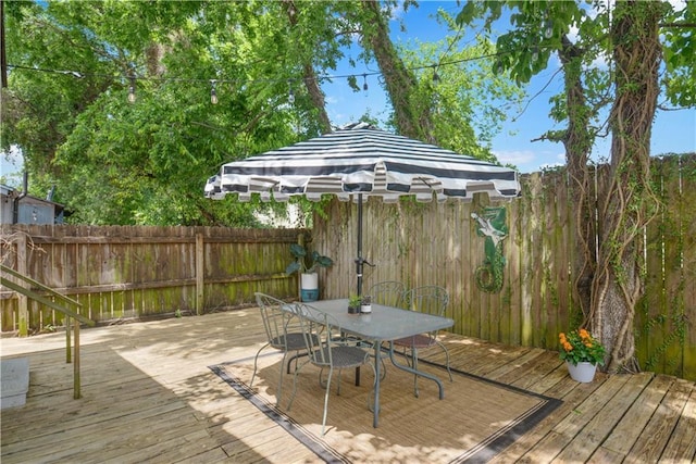210911 Josephine St, New Orleans, LA 70113 - wooden deck with a fenced backyard and outdoor dining area