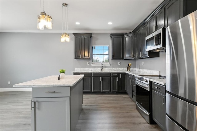 263638 Flood St, New Orleans, LA 70117 - kitchen featuring appliances with stainless steel finishes, ornamental molding, light wood-type flooring, light stone counters, and decorative light fixtures