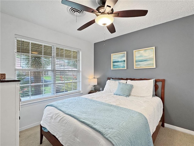 121 Matthews Dr, Slidell, LA 70458 - carpeted bedroom featuring baseboards, ceiling fan, and a textured ceiling
