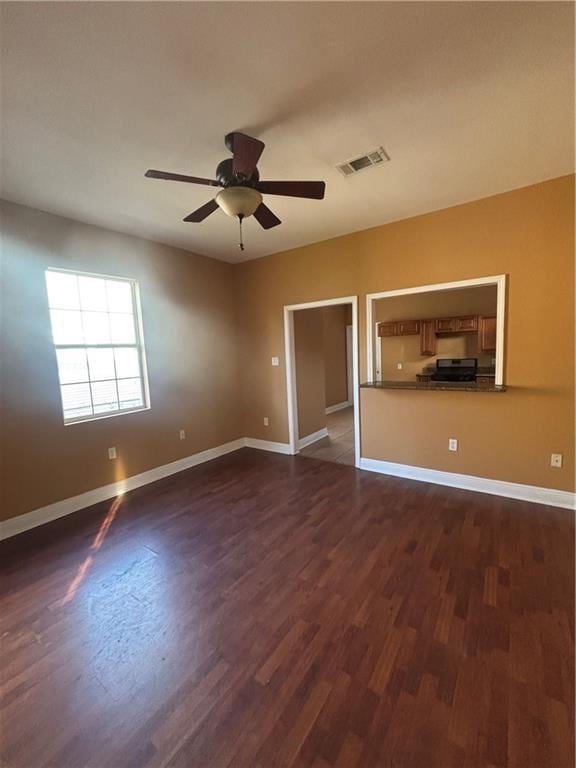 2428 Hamilton St, New Orleans, LA 70118 - unfurnished room with dark wood-style flooring, a ceiling fan, and baseboards