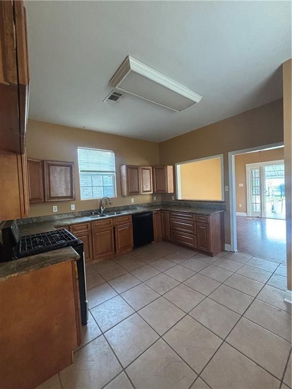 2428 Hamilton St, New Orleans, LA 70118 - kitchen featuring dishwasher, healthy amount of natural light, light tile patterned floors, and a sink