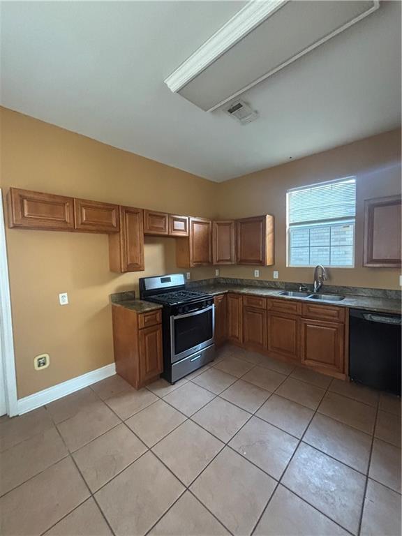 2428 Hamilton St, New Orleans, LA 70118 - kitchen with stainless steel gas range, black dishwasher, a sink, brown cabinetry, and light tile patterned floors