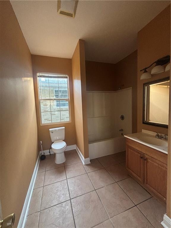 2428 Hamilton St, New Orleans, LA 70118 - bathroom with toilet, vanity, tile patterned floors, shower / washtub combination, and baseboards