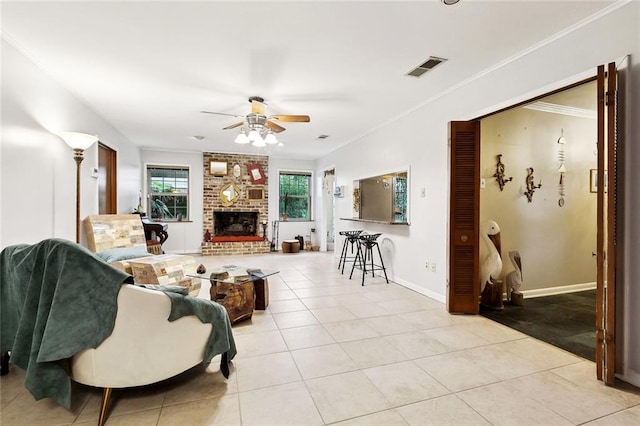5238 Macarthur Blvd, New Orleans, LA 70131 - living room with a ceiling fan, light tile patterned flooring, a fireplace, ornamental molding, and baseboards