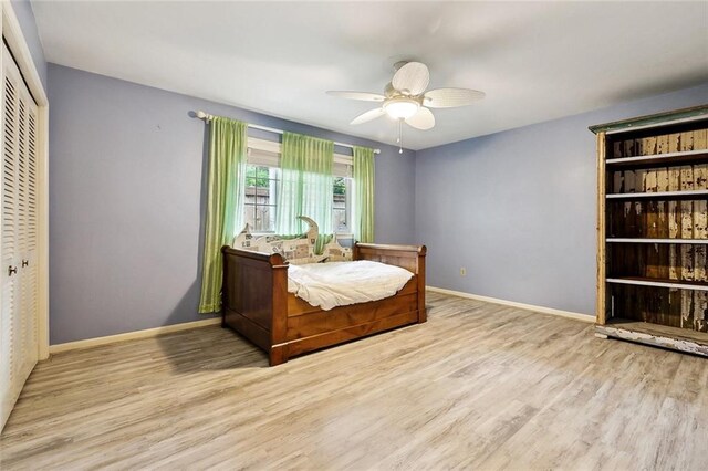 5238 Macarthur Blvd, New Orleans, LA 70131 - bedroom featuring wood finished floors, a closet, baseboards, and ceiling fan