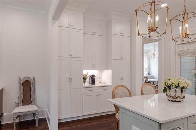 1302 W 23rd Ave, Covington, LA 70433 - kitchen featuring a chandelier, light countertops, dark wood-style floors, white cabinets, and crown molding