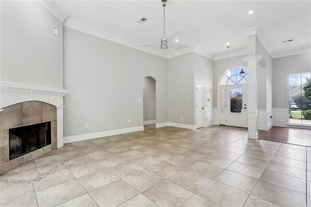 322 Palermo Dr, Slidell, LA 70458 - unfurnished living room featuring ornamental molding, light tile patterned flooring, a tile fireplace, recessed lighting, and arched walkways