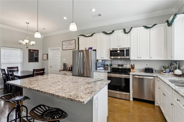 19499 Deerfield Loop, Loranger, LA 70446 - kitchen featuring appliances with stainless steel finishes, a chandelier, a breakfast bar, white cabinets, and a center island