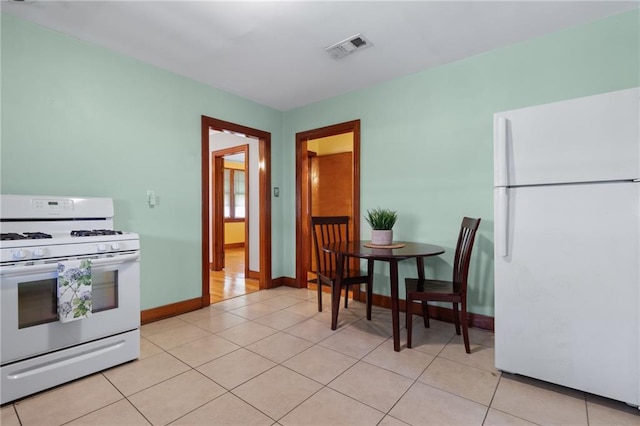 230 Jules Ave, Jefferson, LA 70121 - kitchen featuring white appliances, baseboards, and light tile patterned floors