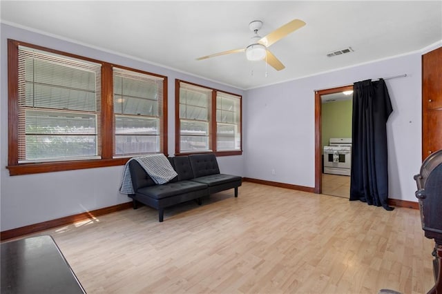 230 Jules Ave, Jefferson, LA 70121 - living area featuring baseboards, plenty of natural light, light wood finished floors, and crown molding