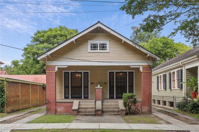 4423 St Ann St, New Orleans, LA 70119 - view of front facade with a porch and brick siding