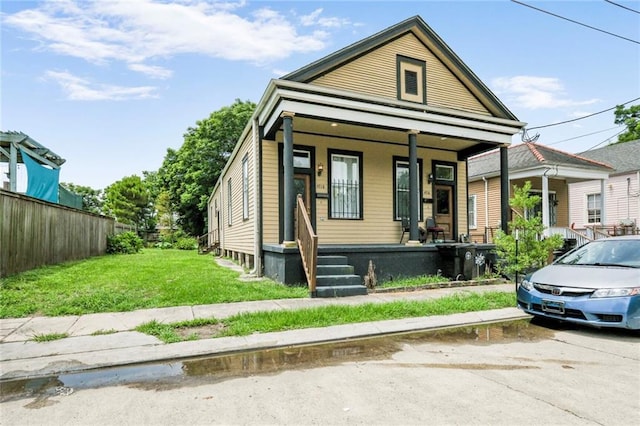 4716-18 Burgundy St, New Orleans, LA 70117 - shotgun-style home with a porch