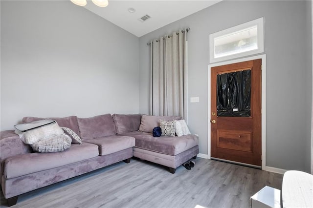 4716-18 Burgundy St, New Orleans, LA 70117 - living area featuring wood finished floors, lofted ceiling, and baseboards