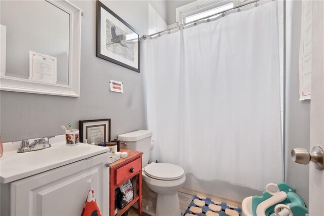 4716-18 Burgundy St, New Orleans, LA 70117 - bathroom featuring vanity, toilet, and a shower with shower curtain