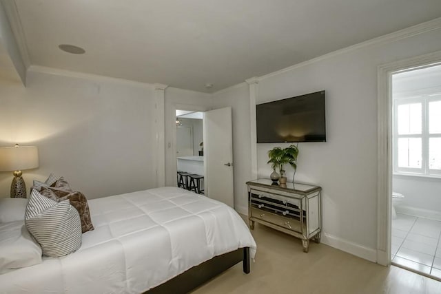 1323 Dauphine St Unit 3, New Orleans, LA 70116 - bedroom with baseboards, ornamental molding, and ensuite bathroom