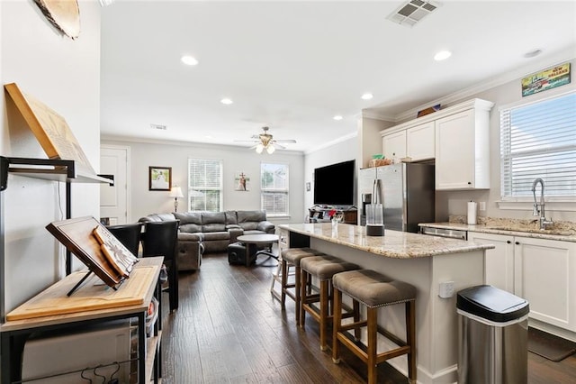 1233 Brockenbraugh Ct, Metairie, LA 70005 - kitchen featuring a sink, stainless steel fridge with ice dispenser, ornamental molding, healthy amount of natural light, and white cabinets