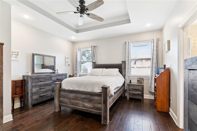 1233 Brockenbraugh Ct, Metairie, LA 70005 - bedroom with dark wood finished floors, a tray ceiling, ceiling fan, baseboards, and recessed lighting
