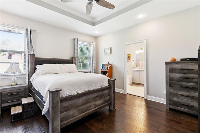 1233 Brockenbraugh Ct, Metairie, LA 70005 - bedroom with dark wood-style flooring, a tray ceiling, recessed lighting, baseboards, and ensuite bath