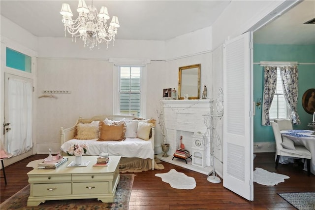 4501 Canal St, New Orleans, LA 70119 - living area featuring wood-type flooring, a chandelier, and a brick fireplace