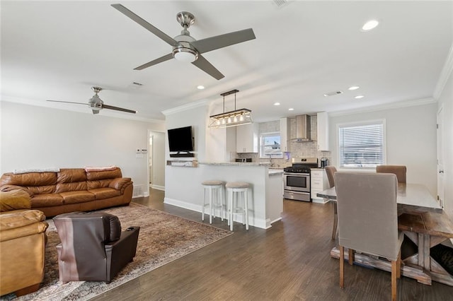 4009 Purdue Dr, Metairie, LA 70003 - living room with ornamental molding, ceiling fan, recessed lighting, dark wood-type flooring, and baseboards