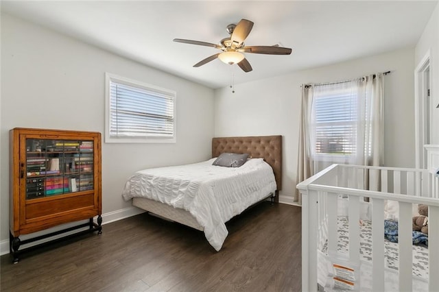 4009 Purdue Dr, Metairie, LA 70003 - bedroom with multiple windows, dark wood-style flooring, baseboards, and a ceiling fan