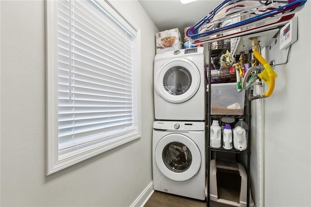 4009 Purdue Dr, Metairie, LA 70003 - washroom featuring stacked washer and clothes dryer, wood finished floors, and baseboards
