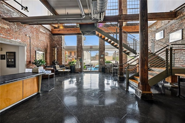 920 Poeyfarre St Unit 373, New Orleans, LA 70130 - lobby featuring a high ceiling, brick wall, stairway, and a view of city
