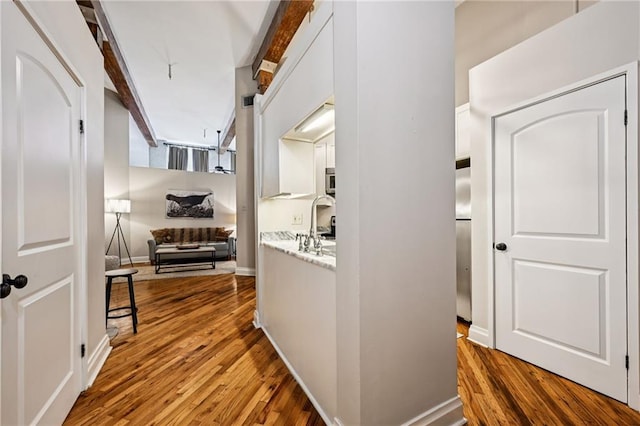 920 Poeyfarre St Unit 373, New Orleans, LA 70130 - corridor featuring wood finished floors, a sink, and beamed ceiling