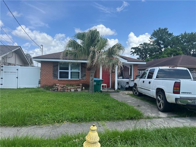 2104 Illinois Ave, Kenner, LA 70062 - view of front of house with a gate, brick siding, and a shingled roof