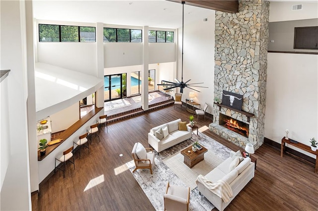73 Doescher Dr, Harahan, LA 70123 - living room featuring a towering ceiling, a fireplace, wood finished floors, and baseboards