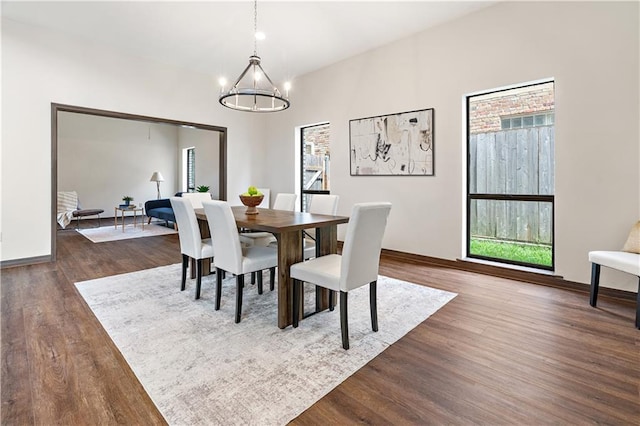 73 Doescher Dr, Harahan, LA 70123 - dining space with a chandelier, dark wood-style floors, healthy amount of natural light, and baseboards