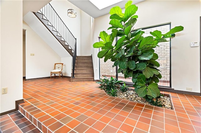 73 Doescher Dr, Harahan, LA 70123 - tiled foyer featuring baseboards, stairs, and a high ceiling