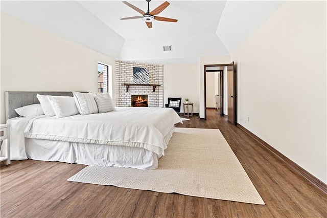 73 Doescher Dr, Harahan, LA 70123 - bedroom featuring dark wood-type flooring, vaulted ceiling, a fireplace, baseboards, and ceiling fan