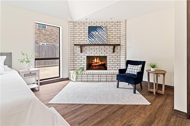73 Doescher Dr, Harahan, LA 70123 - bedroom featuring lofted ceiling, wood finished floors, a fireplace, and baseboards