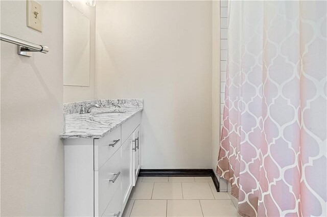 73 Doescher Dr, Harahan, LA 70123 - full bath with vanity, tile patterned flooring, a shower with shower curtain, and baseboards