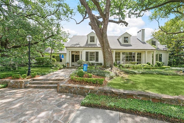 105 Mulberry Dr, Metairie, LA 70005 - cape cod-style house featuring a chimney and a front yard