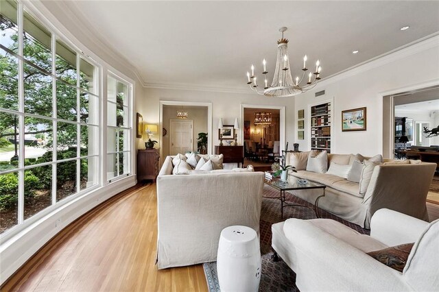 105 Mulberry Dr, Metairie, LA 70005 - living room with a chandelier, plenty of natural light, light wood-style floors, and ornamental molding